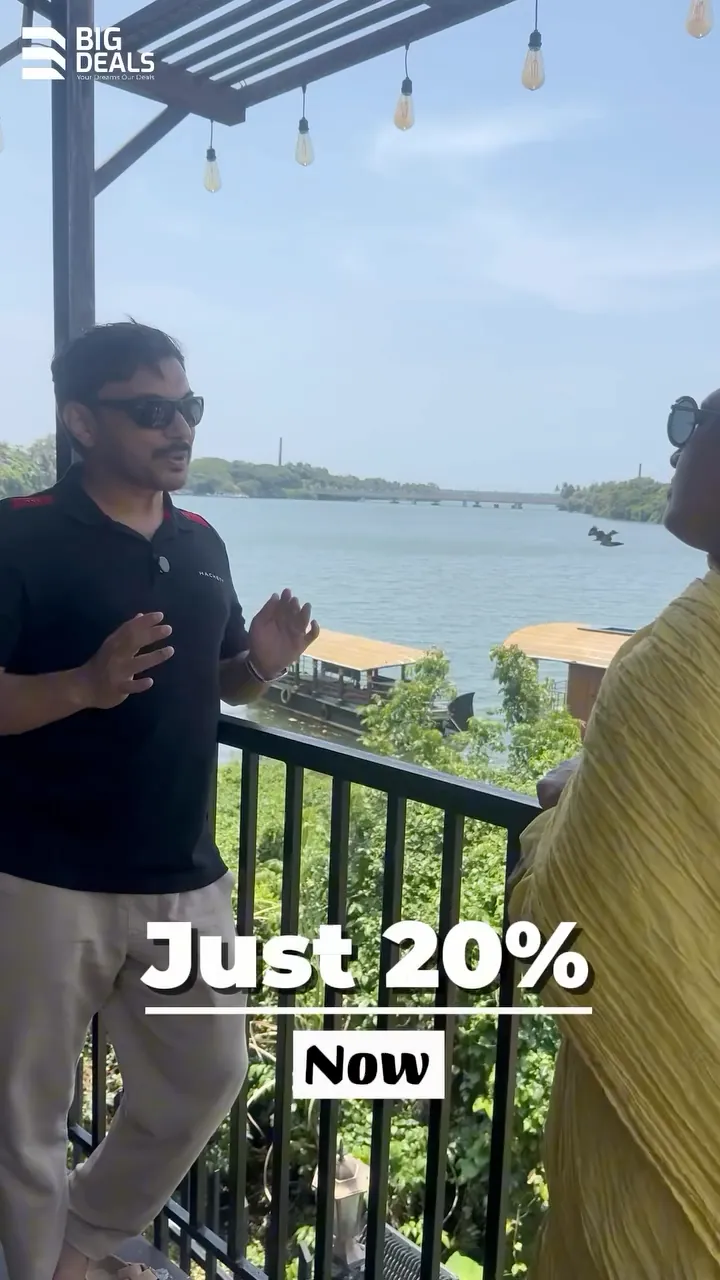 A presenter on a balcony over the river under the words Just 20% Now, near the end of Big Deals' Sobha Bellevue film