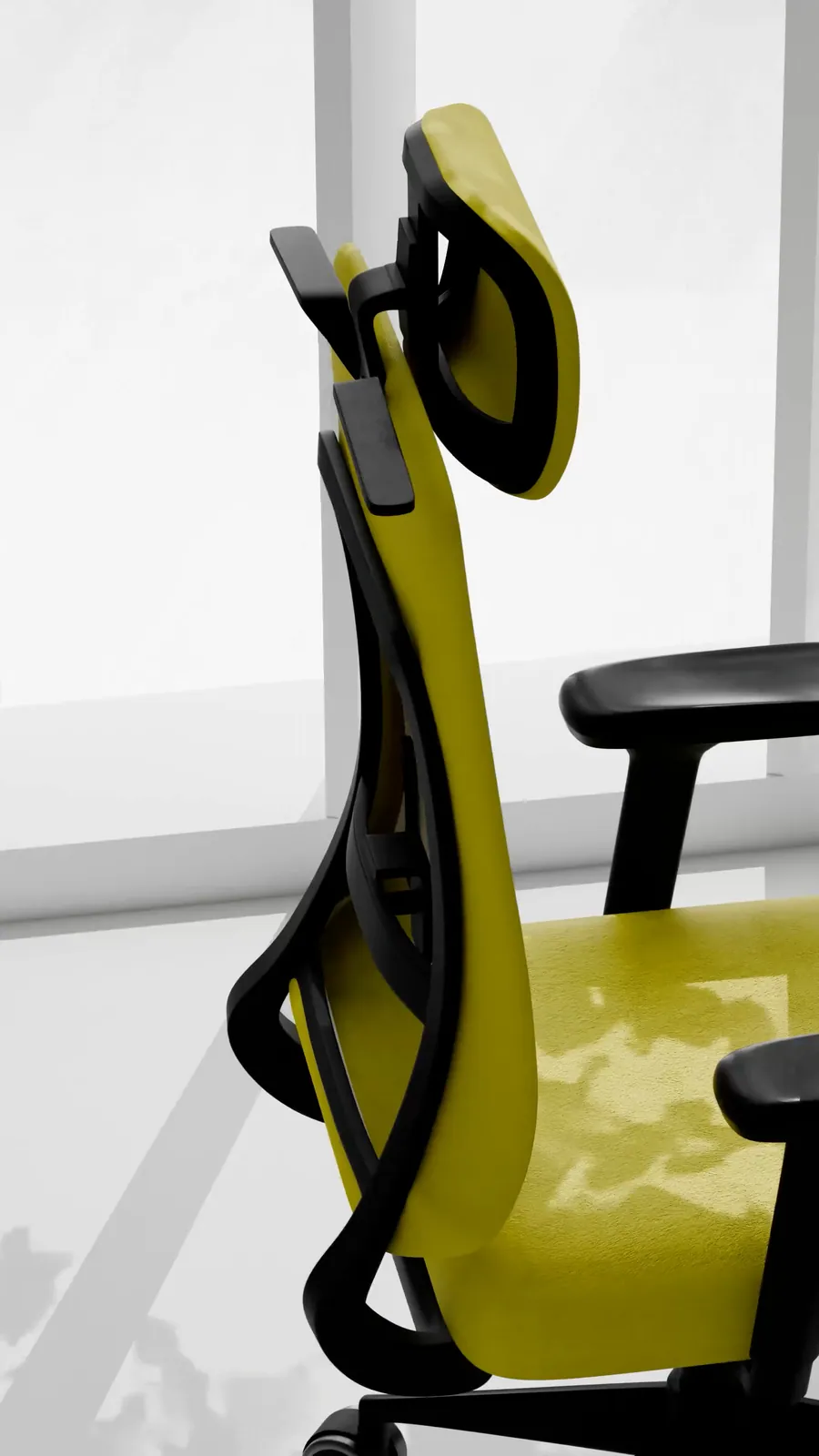 Side profile of the lime mesh high-back in window light with leaf shadows