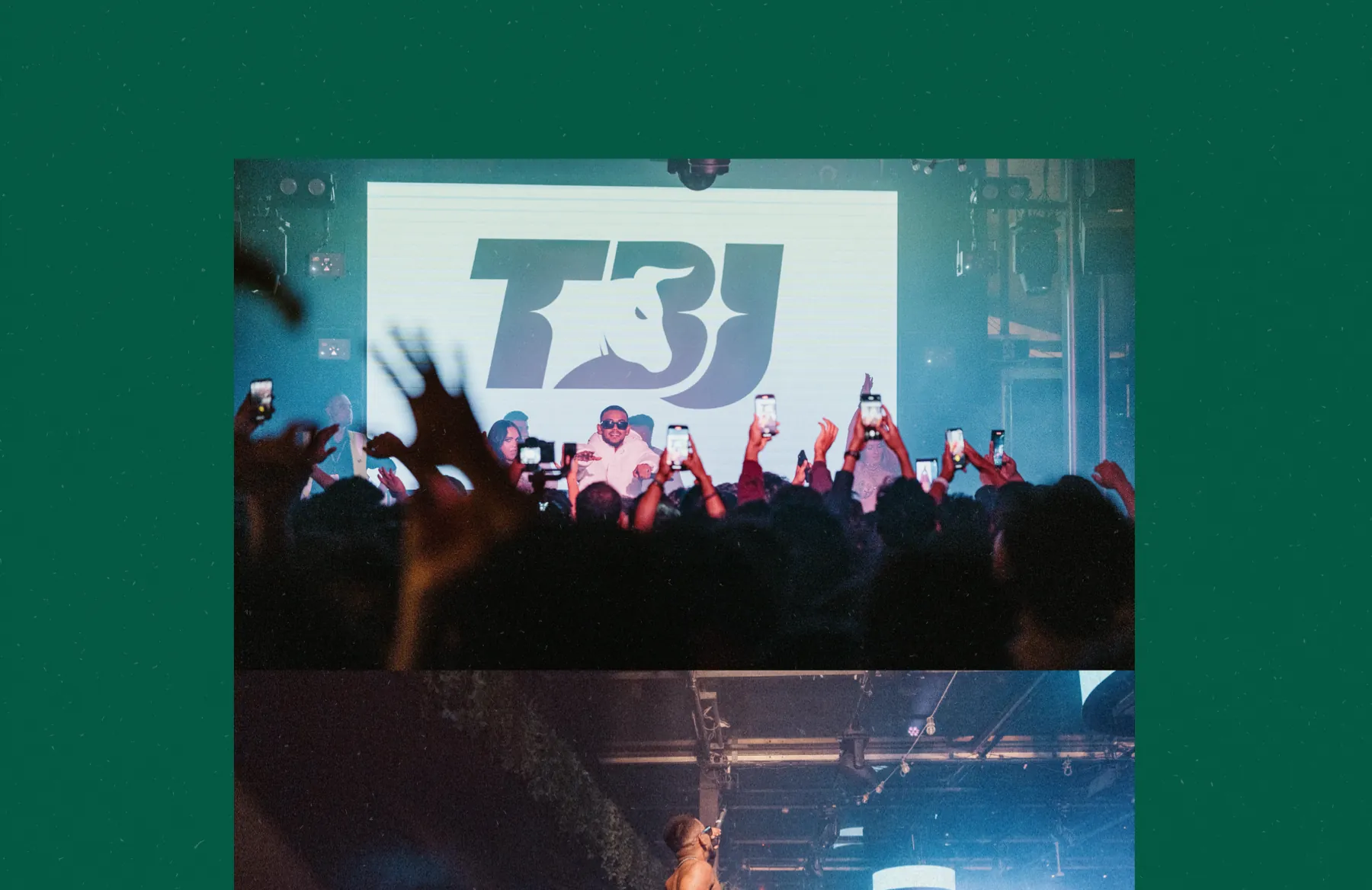 The monogram on the stage screen behind the artist, over a crowd of raised phones.