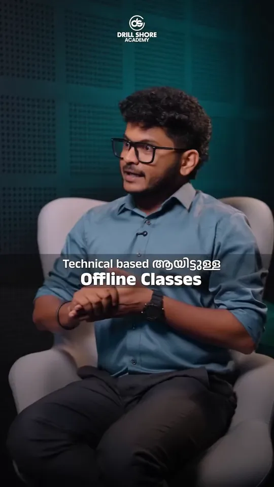 A man in glasses and a blue-grey shirt in an armchair against teal acoustic panels, with the words Technical based Offline Classes on screen, in a reel we made for Drillshore Academy