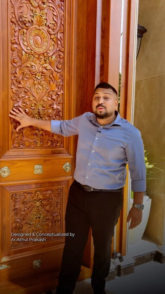 A presenter in a blue shirt beside a tall hand-carved wooden door, on the cover of a Luxart Builders reel