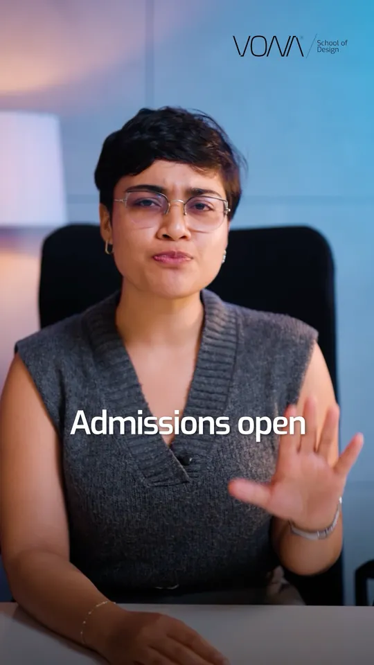 Presenter at a desk against a blue wall, raising a hand beside the words Admissions open, in a VONA School of Design Meta ad