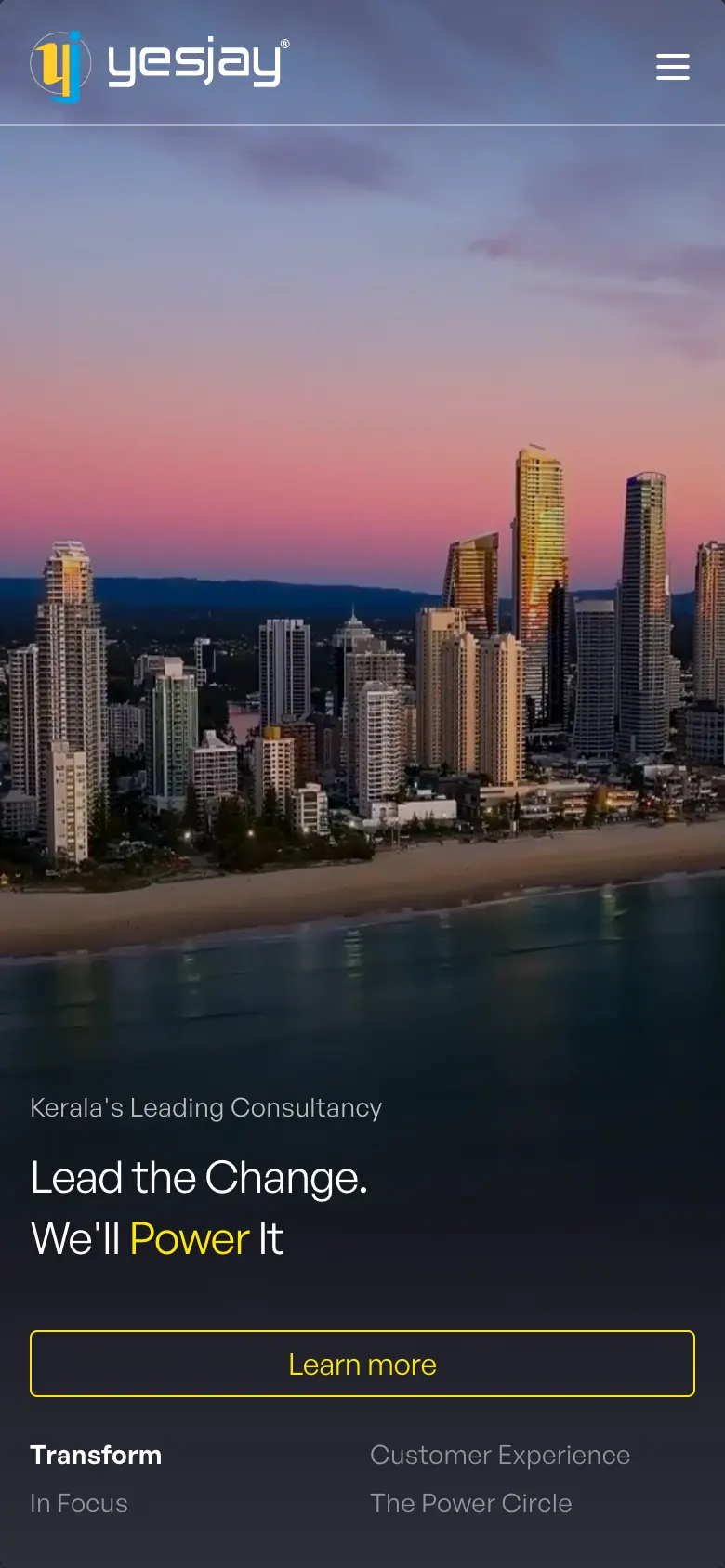 The Yesjay Associates home page on a phone: Kerala's Leading Consultancy, Lead the Change. We'll Power It, over a city skyline at dusk, with a Learn more button